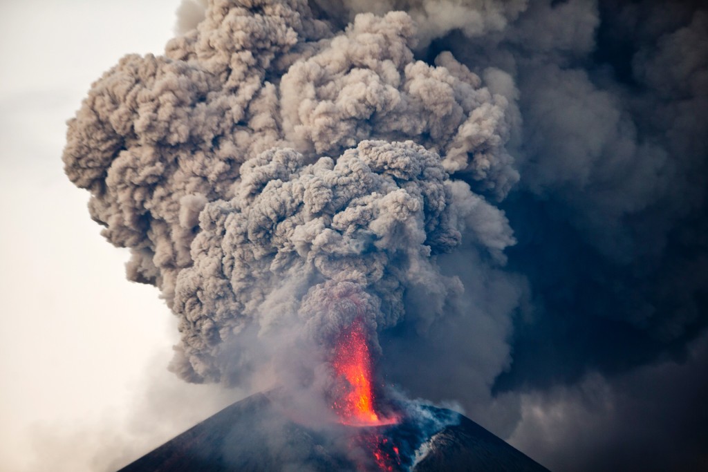 The Momotombo volcano spews a large plume of gas and ash as seen from the rural community of Papalonal, in Leon, Nicaragua, Wednesday, Dec. 2, 2015. Quiet for many years, the volcano emitted some glowing rock on Wednesday, after gas and ash emissions began Tuesday. In 1610, the city of Leon was destroyed during an eruption of the Momotombo and was relocated west, where it is currently located. (AP Photo/Esteban Felix)